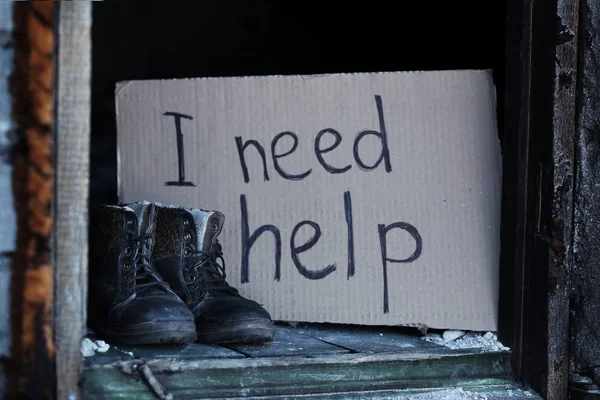 Dirty boots and piece of cardboard — Stock Photo, Image