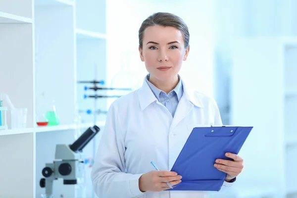 Científico con portapapeles en laboratorio — Foto de Stock