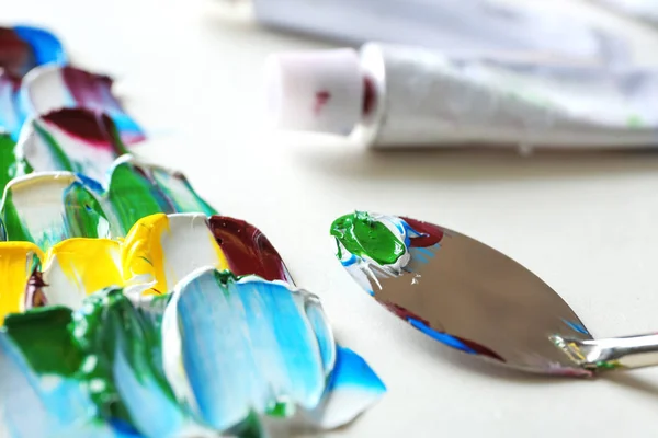 Colorful paints, palette knife and used tube, closeup — Stock Photo, Image