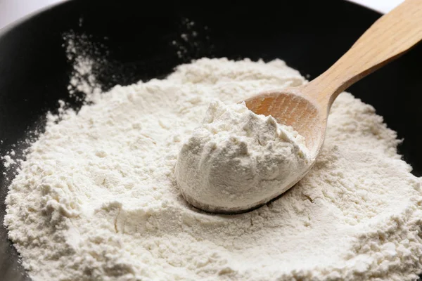 Taking wheat flour from bowl — Stock Photo, Image