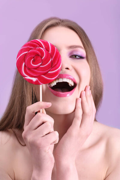 beautiful young woman with lollipop
