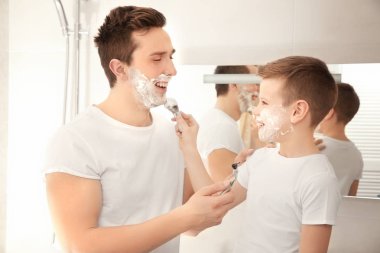 Father and son shaving  clipart