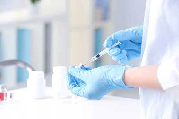 Doctor with syringe and medicine — Stock Photo, Image