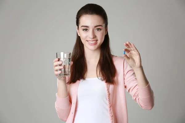 Beautiful young woman with pill — Stock Photo, Image