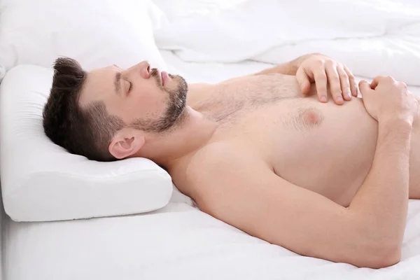Young man lying on bed — Stock Photo, Image