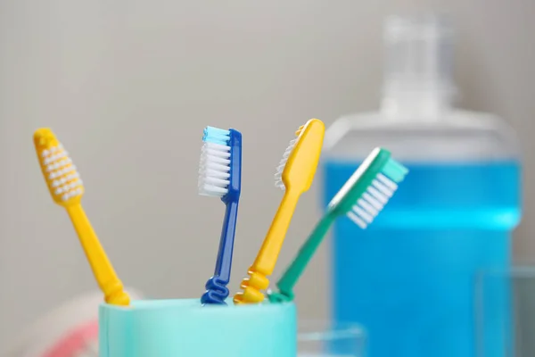 Cup with colorful toothbrushes — Stock Photo, Image