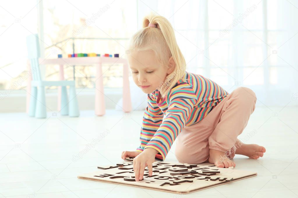 little girl playing with letters