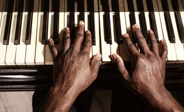 Man hands playing piano