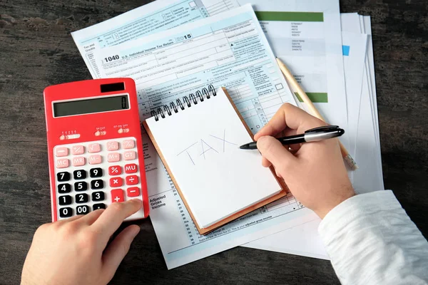 Man working with calculator and documents — Stock Photo, Image