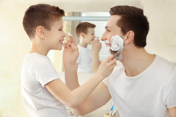 Father and son shaving