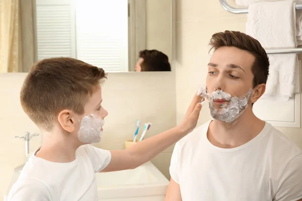 Father and son shaving