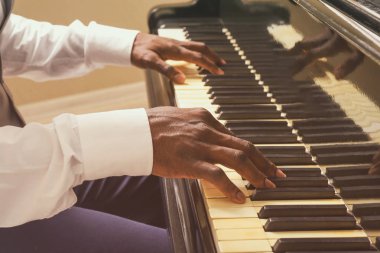 Man hands playing piano