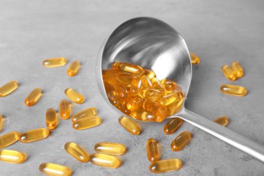 Balık yağı kapsülleri masada pota