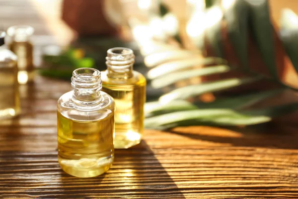 Perfume bottles on wooden table — Stock Photo, Image