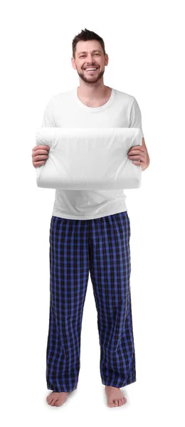 Mladý muž v pyžamu drží polštář — Stock fotografie