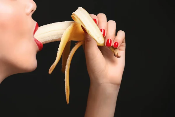 young woman eating banana