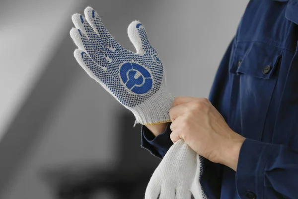 Manos de mecánico automotriz poniéndose guantes — Foto de Stock