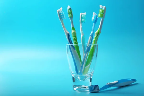 Colorful toothbrushes in glass — Stock Photo, Image