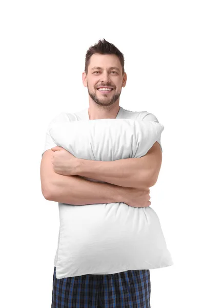 Mladý muž v pyžamu drží polštář — Stock fotografie
