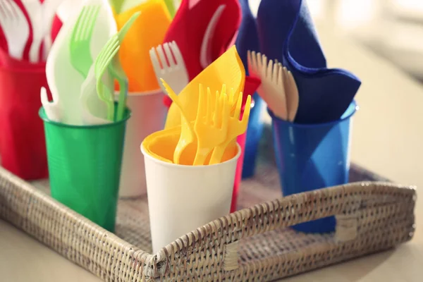 Plastic ware in wicker tray