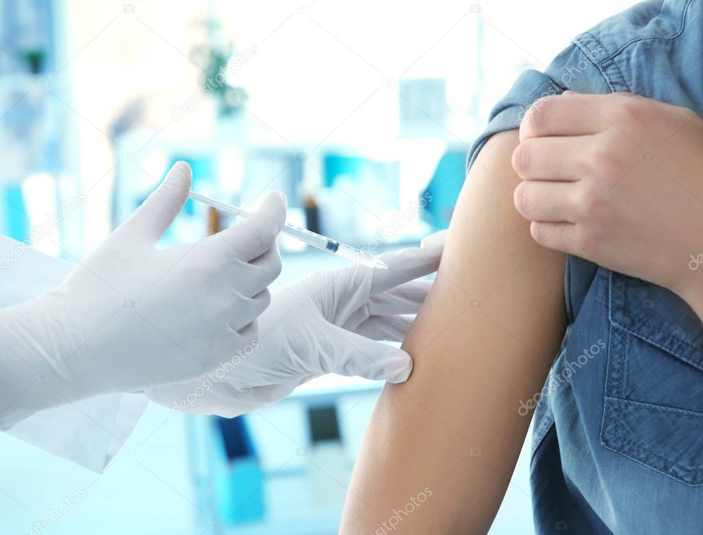 Doctor vaccinating patient in clinic