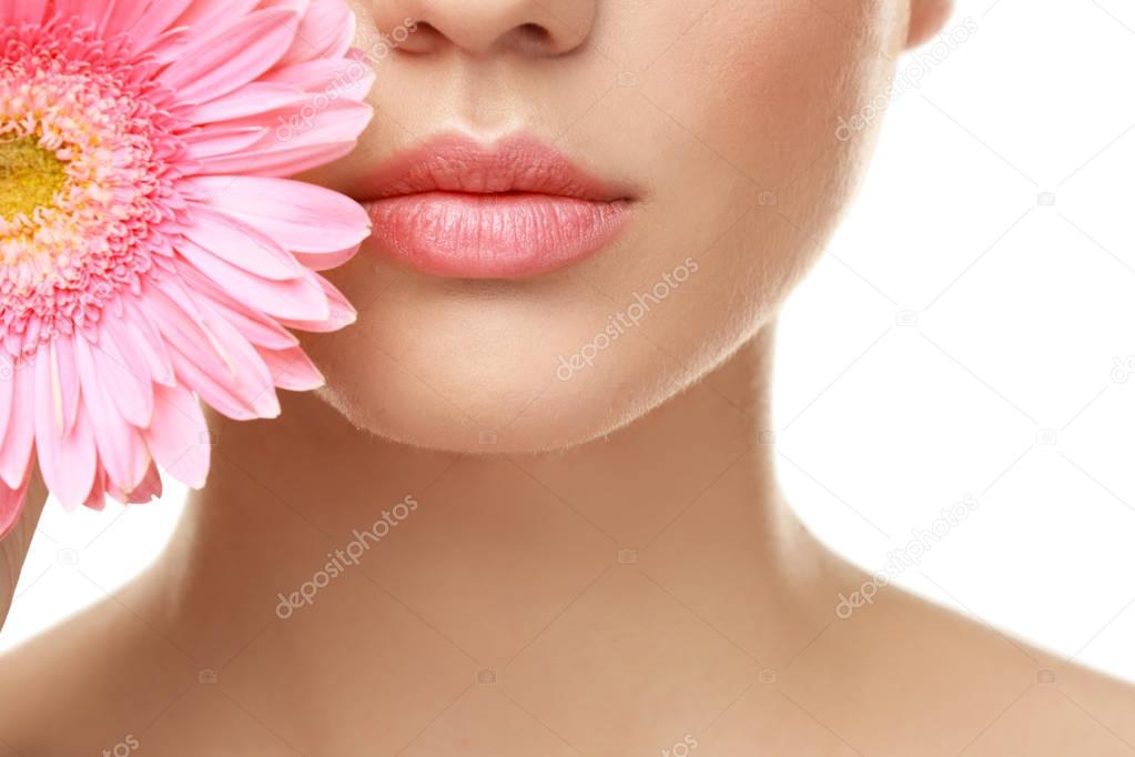 Beautiful young woman with flower