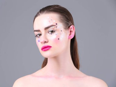 Yaratıcı makyajlı genç bir kadın.