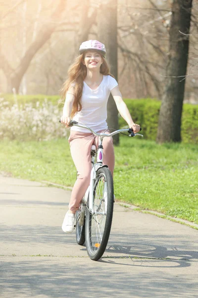 Girl in helmet cycling in park — Stock Photo, Image