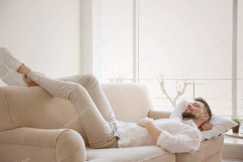 young man resting on sofa