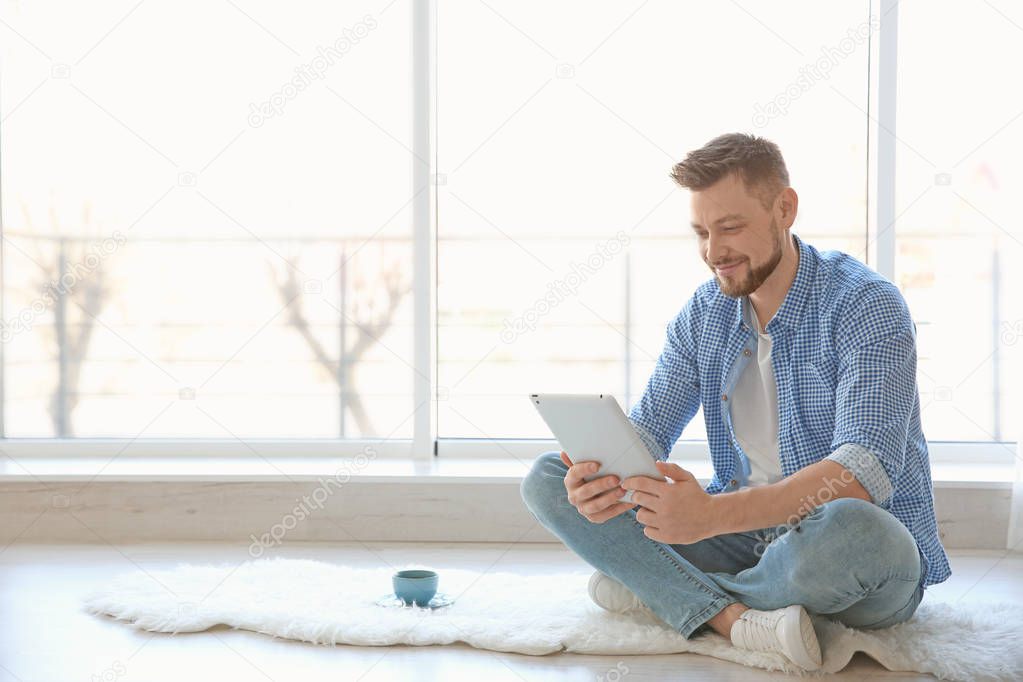 Happy young man using tablet