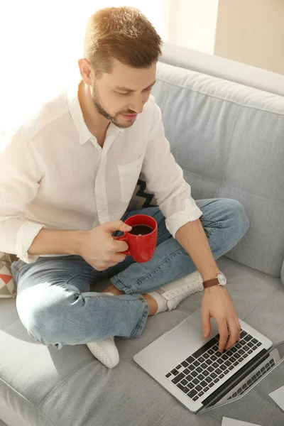 Handsome young man with laptop — Stock Photo, Image