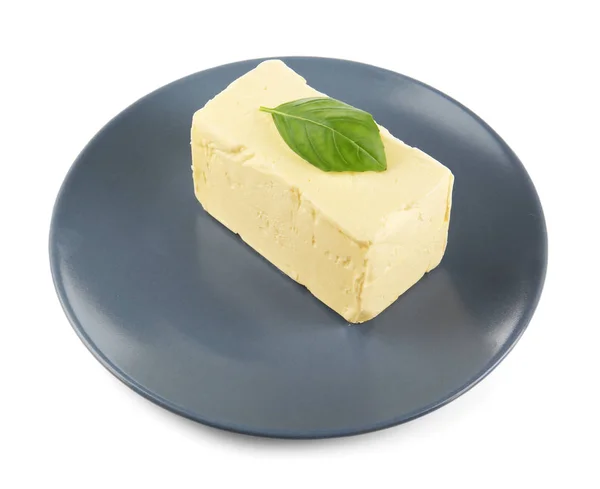 Plate with butter and basil leaf — Stock Photo, Image