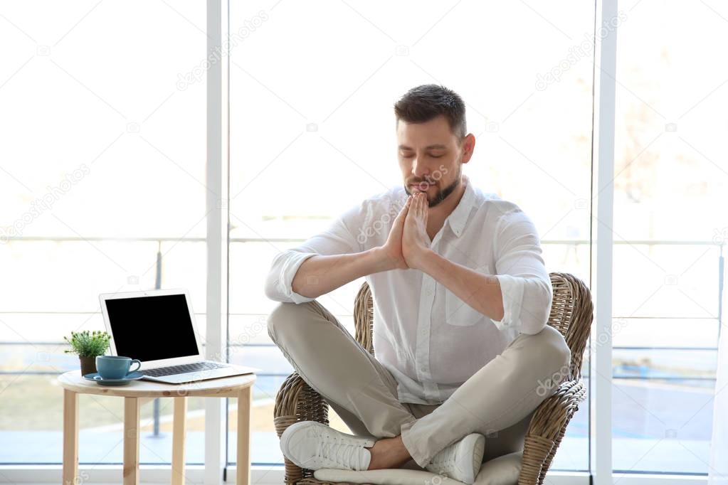 Happy young man meditating