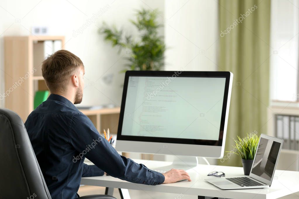 Young programmer at workplace 