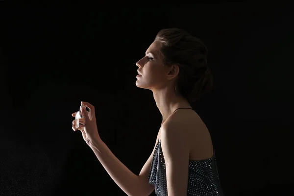 Young woman with bottle of perfume — Stock Photo, Image