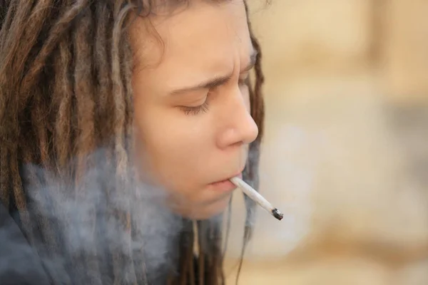 Young boy smoking weed, closeup