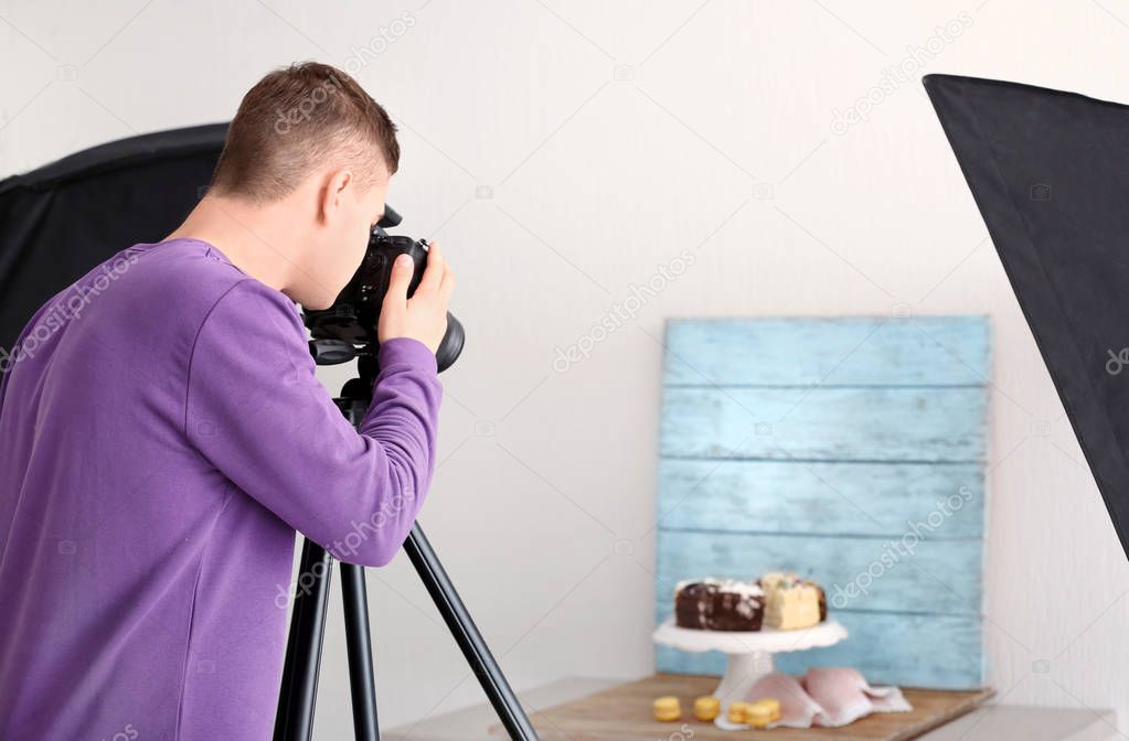 man photographing food