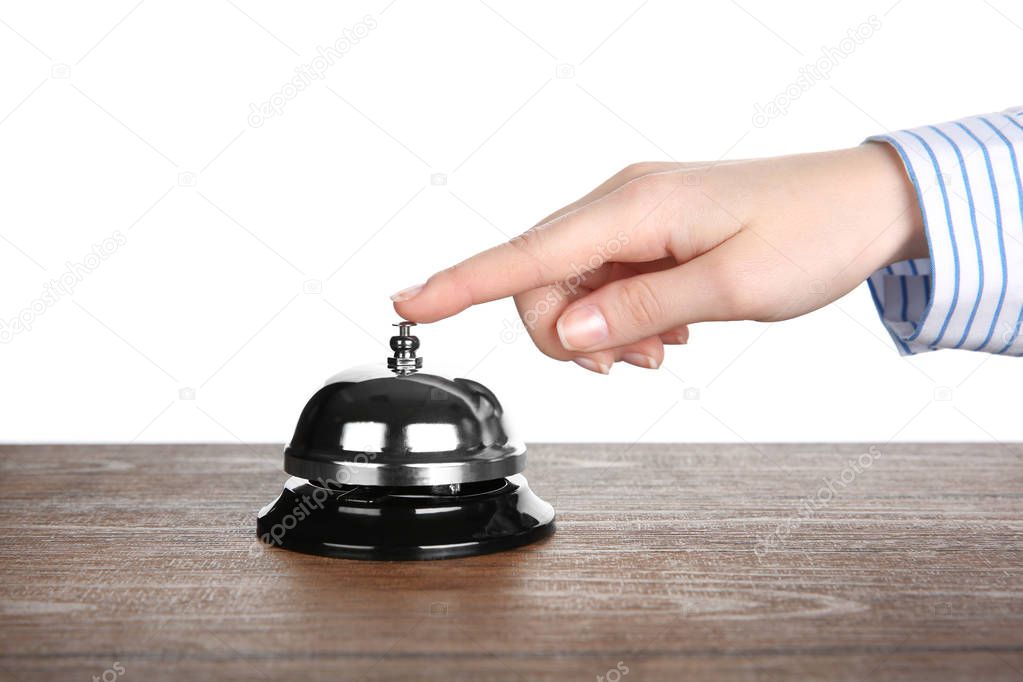 Female hand ringing a service bell 