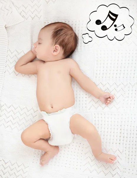 Aranyos baba alszik a kockás. Altató dal és zene fogalma — Stock Fotó