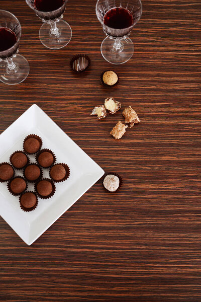 Wine and chocolates on wooden background