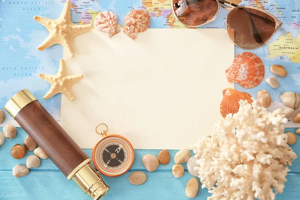 Travel concept. Composition with paper and sea shells on world map background — Stock Photo, Image