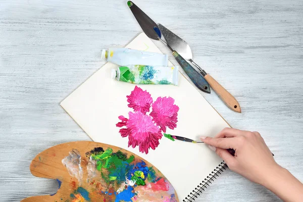 Woman painting flowers