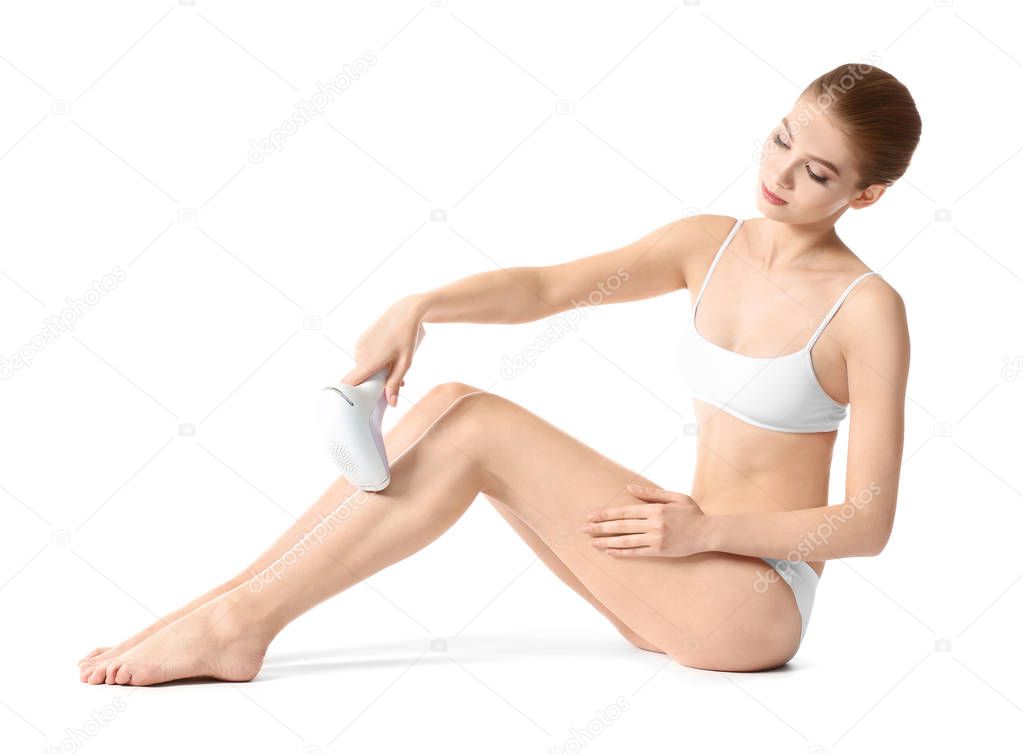 Beautiful young woman epilating legs