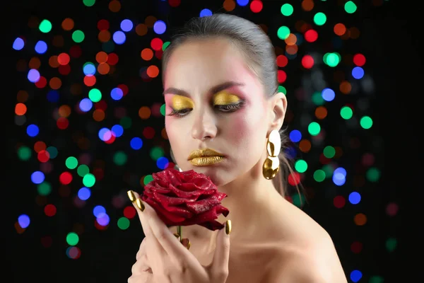 Beautiful woman with holiday makeup against defocused lights — Stock Photo, Image