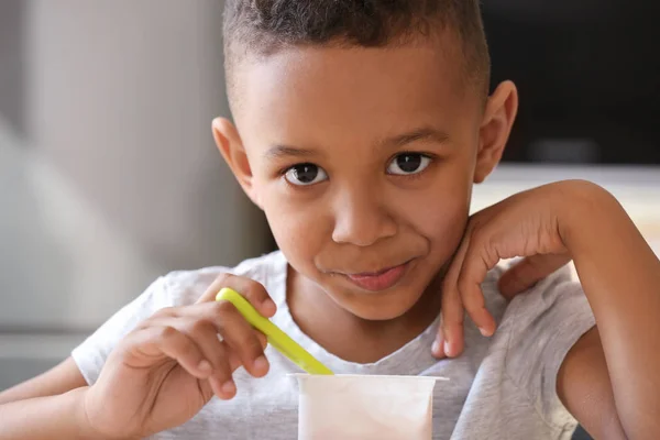 Afro-americano menino comendo iogurte — Fotografia de Stock