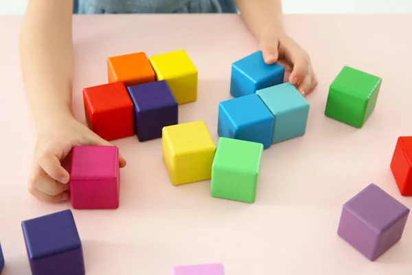 Hands of child playing with colorful cubes — Stock Photo, Image