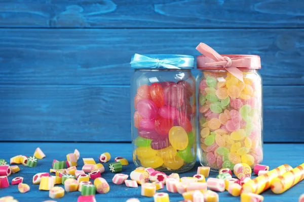 Composition of different candies on wooden background — Stock Photo, Image