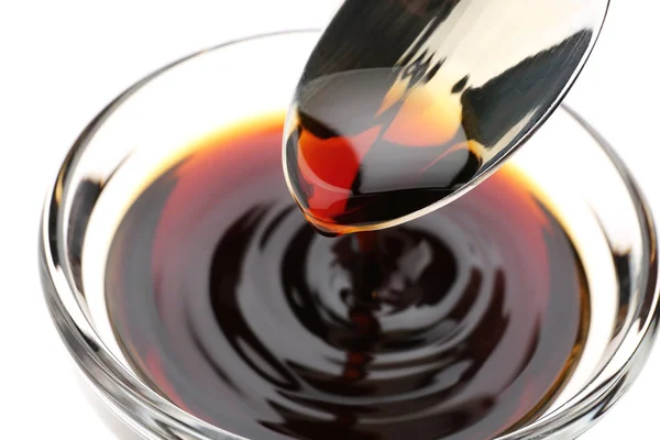 Bowl with tasty soy sauce and spoon, closeup — Stock Photo, Image