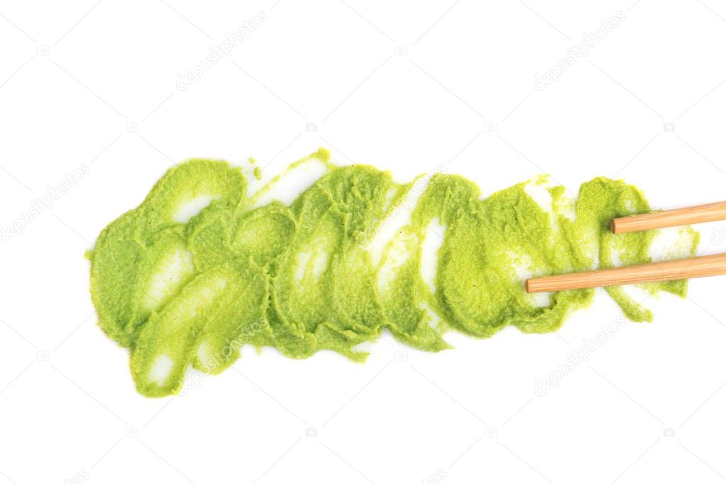 Wasabi sauce and chopsticks isolated on white