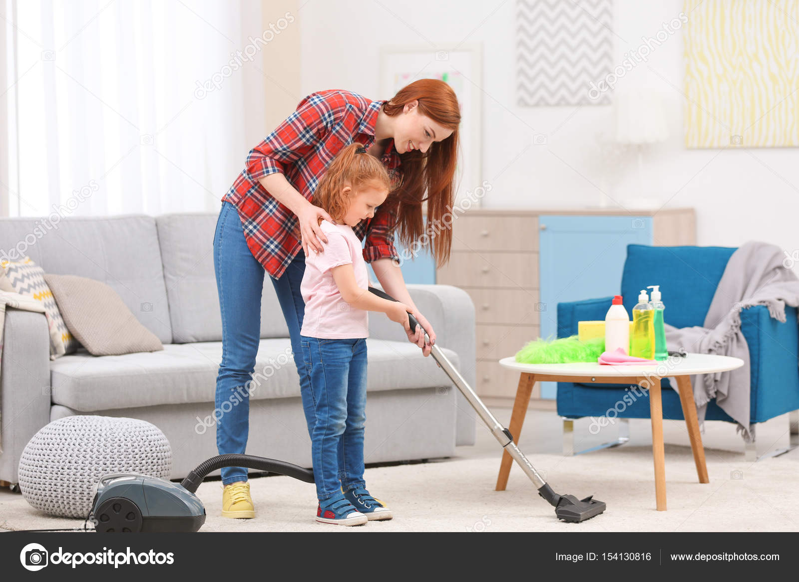 Little girl using vacuum cleaner Stock Photo by ©belchonock 154130816